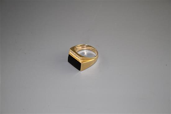 A 14k yellow metal, diamond and black onyx set dress ring, size U/V, gross weight 8.4 grams.